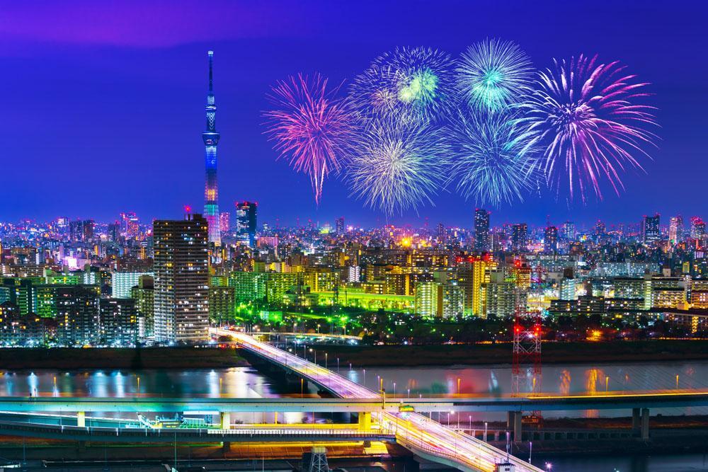 Fireworks celebrating over Tokyo cityscape at night, Japan